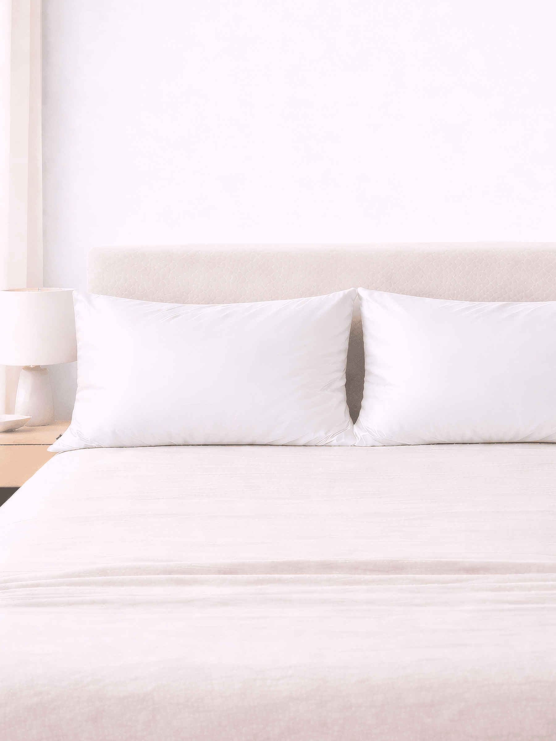 king size pure white silk pillowcases on a bed